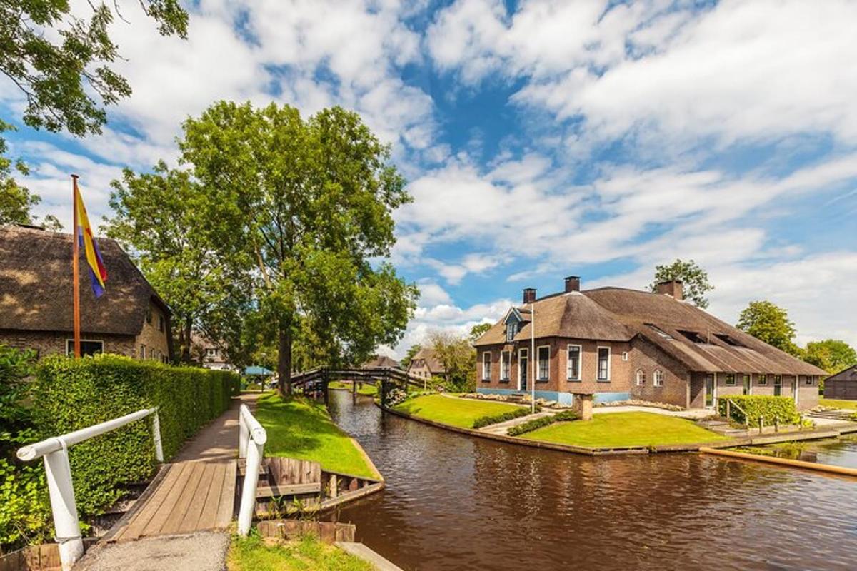a house next to a river with a bridge