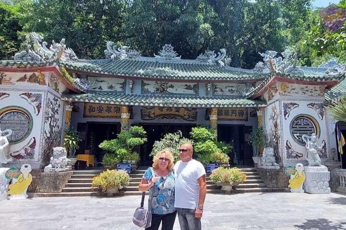 a man and a woman standing in front of a building