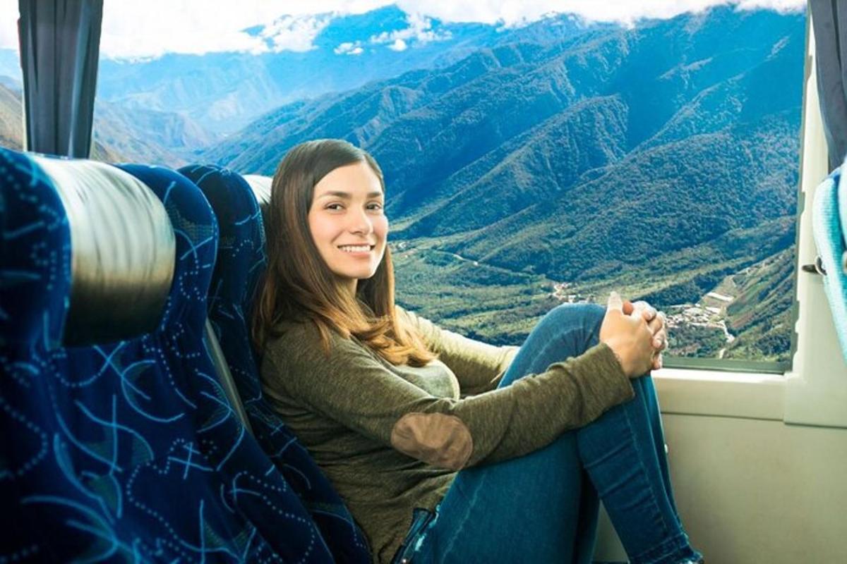 a woman sitting in an airplane seat looking out a window