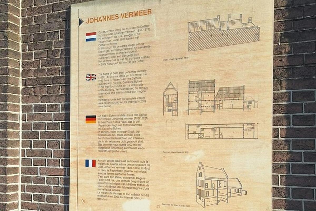 a poster on a wall next to a brick wall