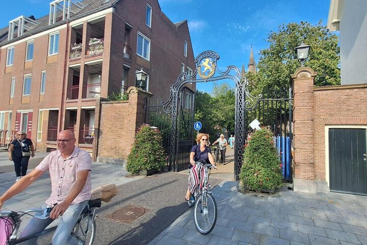 a man and a woman riding a bike down a street