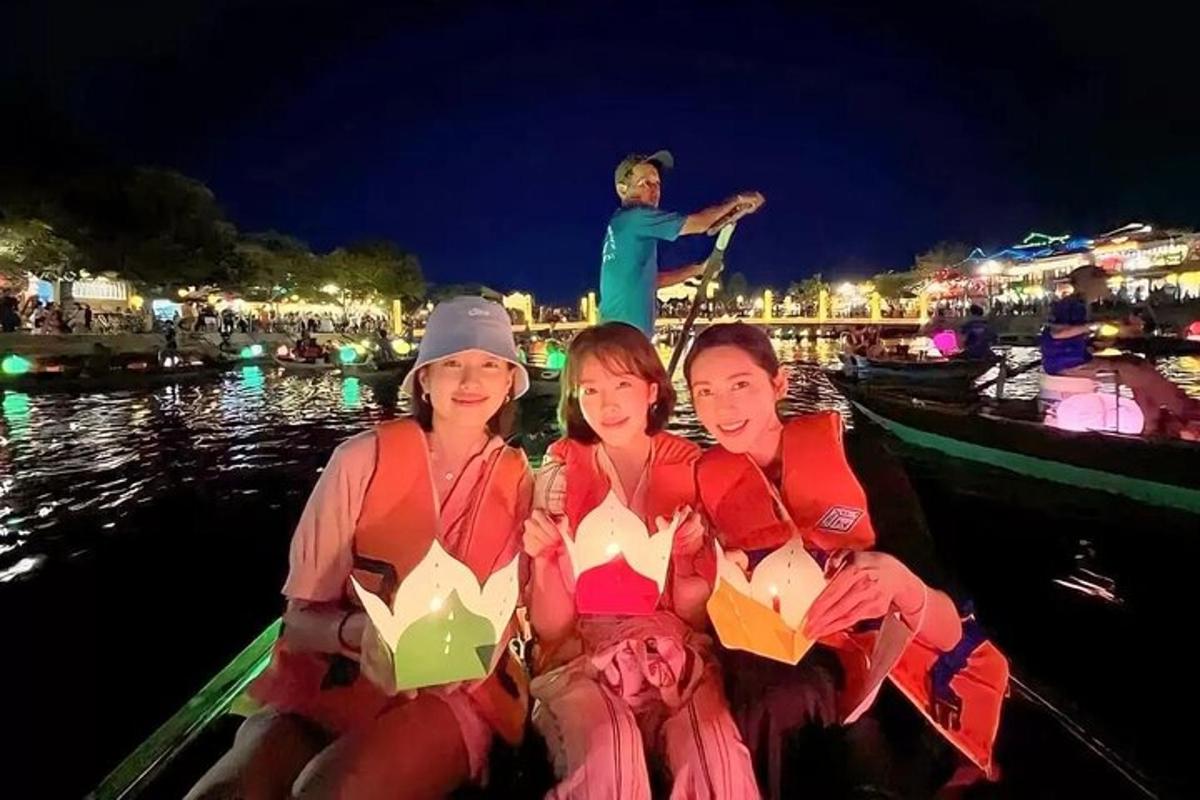 un gruppo di donne sedute su una barca di notte