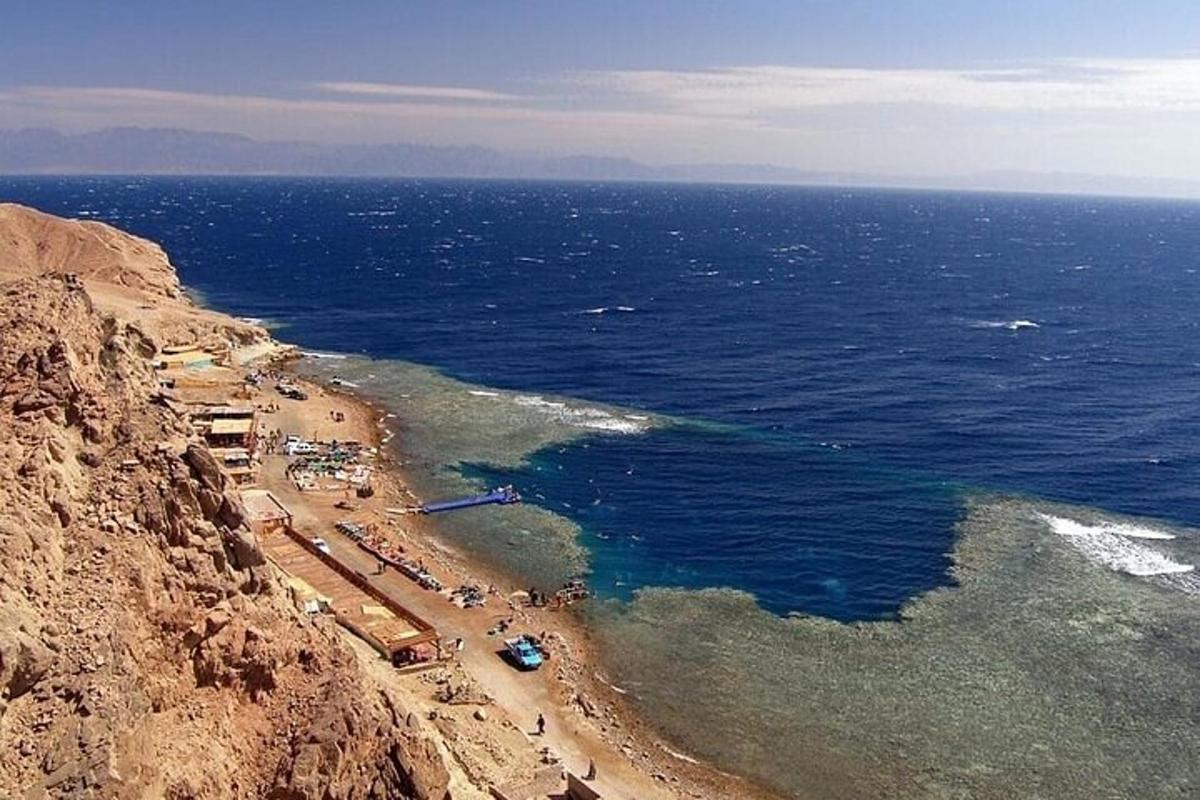 an aerial view of a beach on the side of a mountain