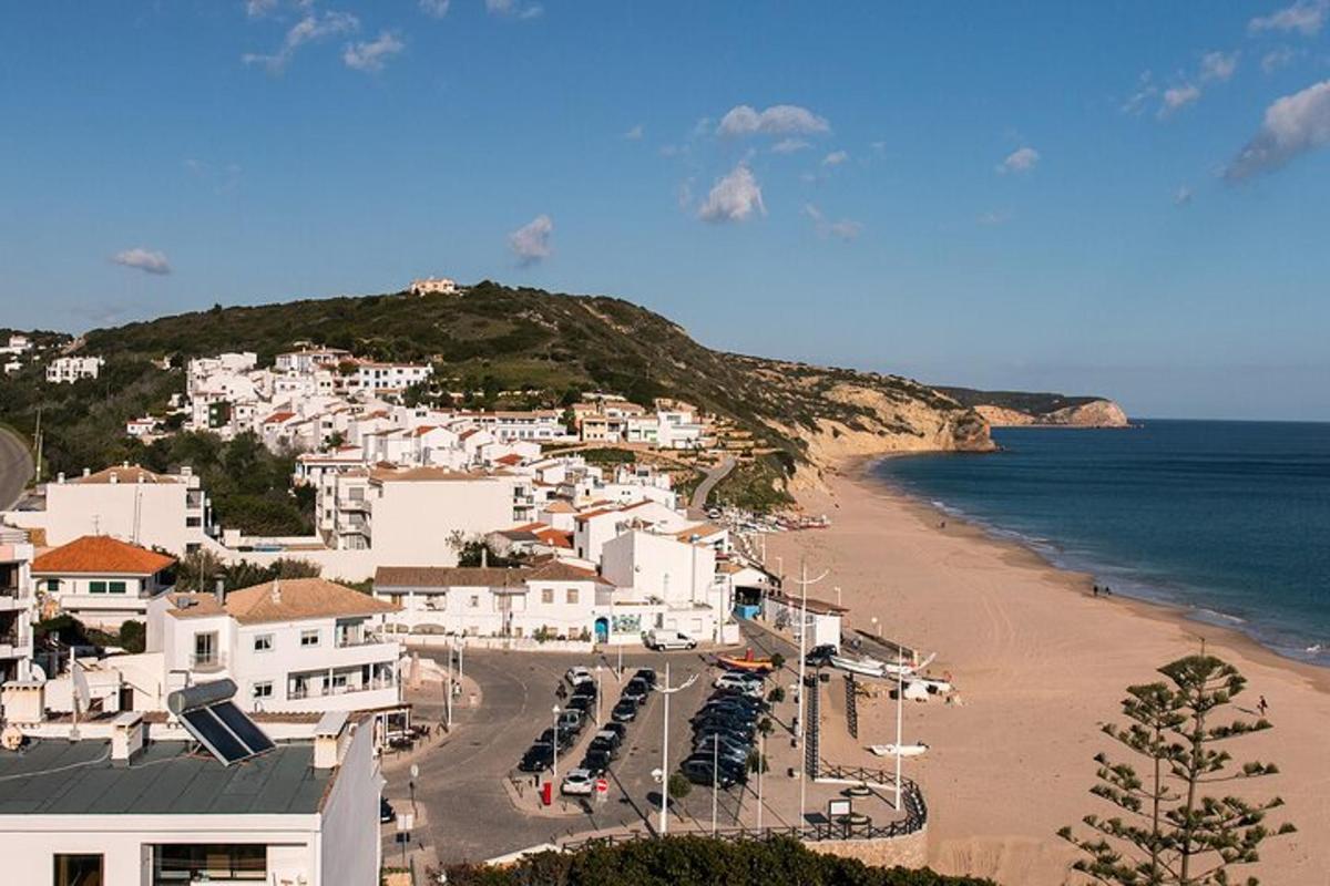 a view of a beach with white buildings and the ocean