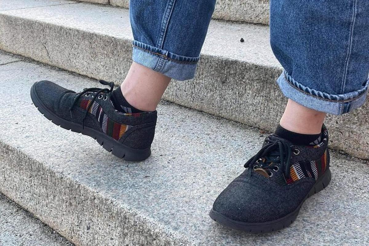 a person walking down some steps in black shoes