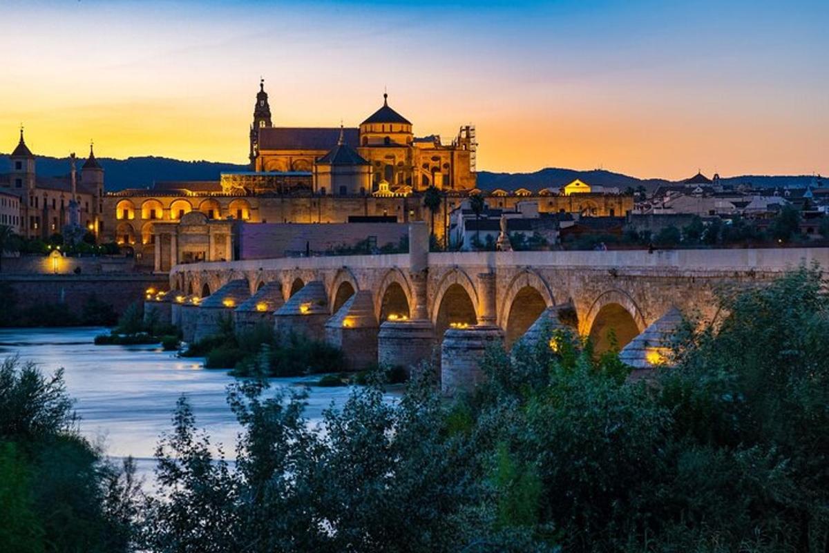a bridge over a river in front of a building