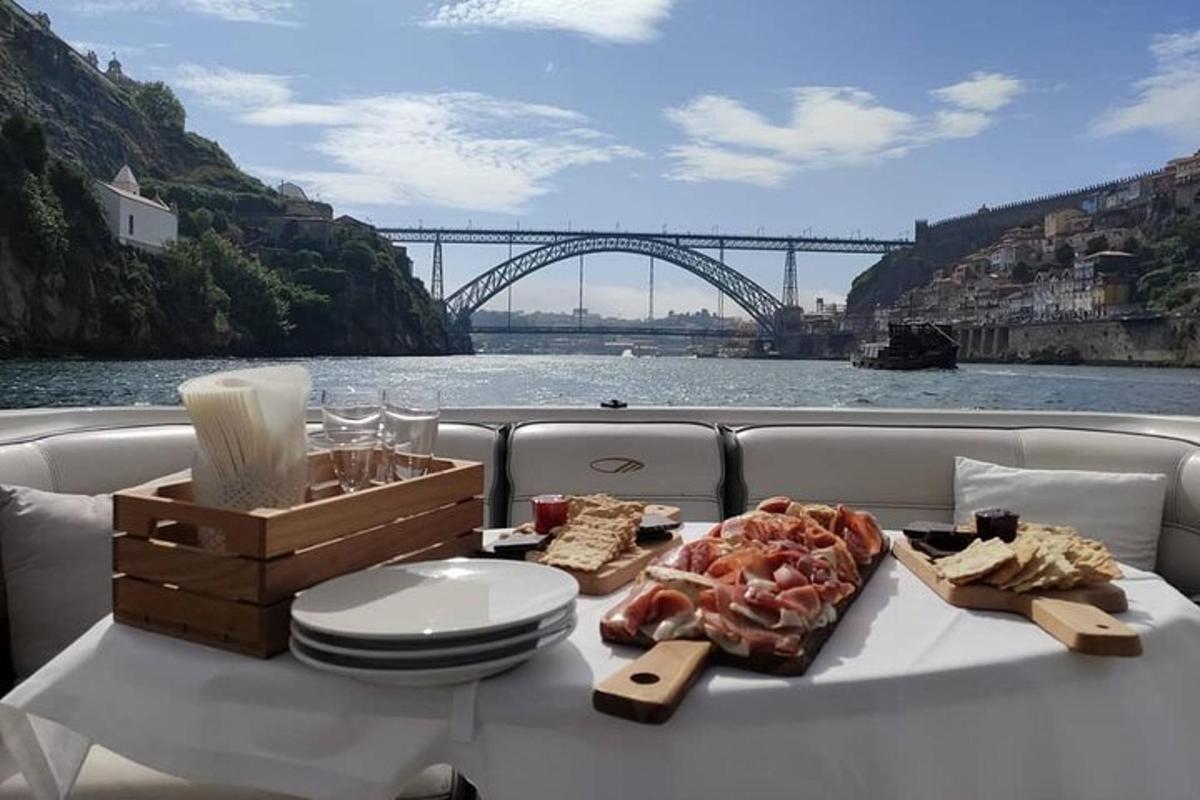 a plate of food on a boat with a view of a bridge