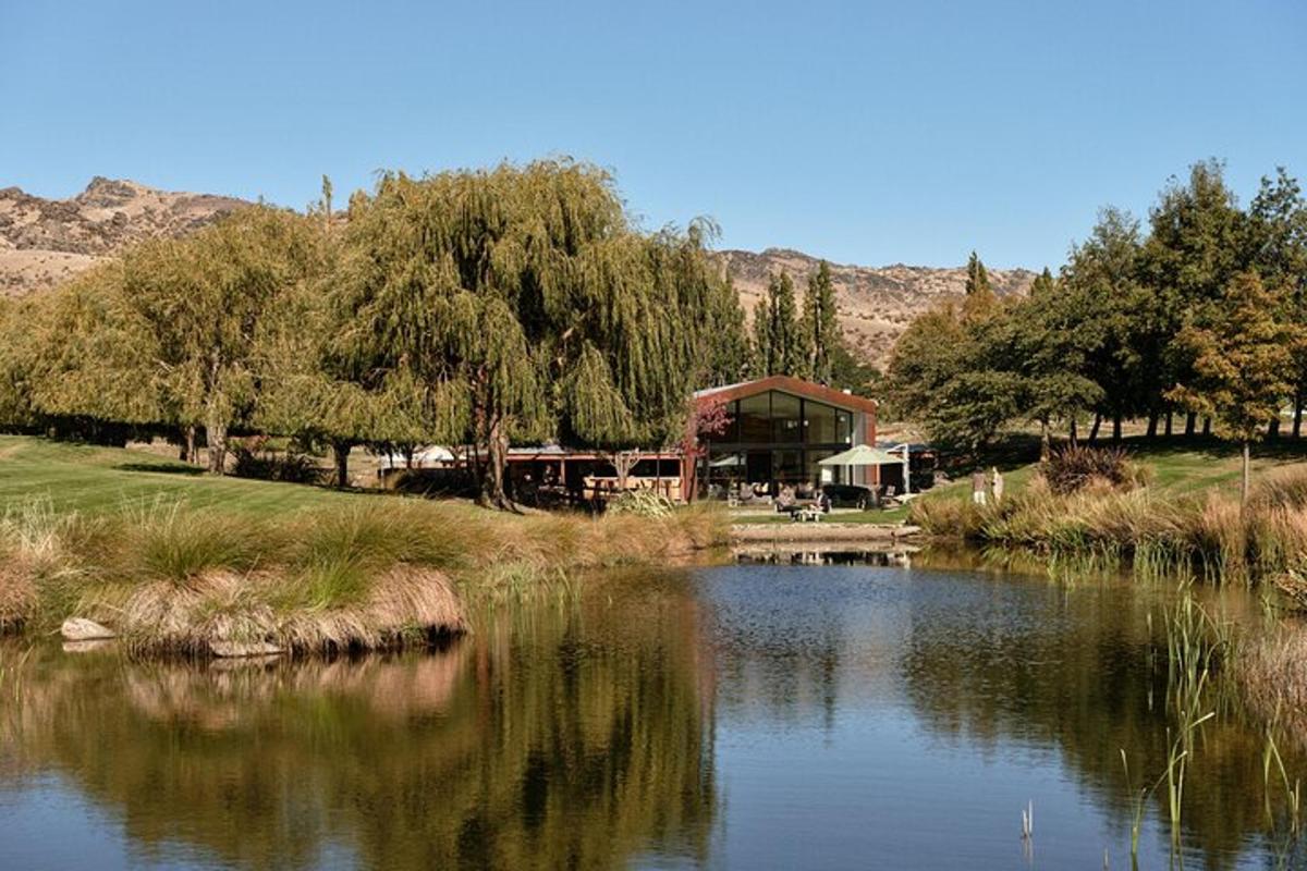 a lake with a building in the background with trees