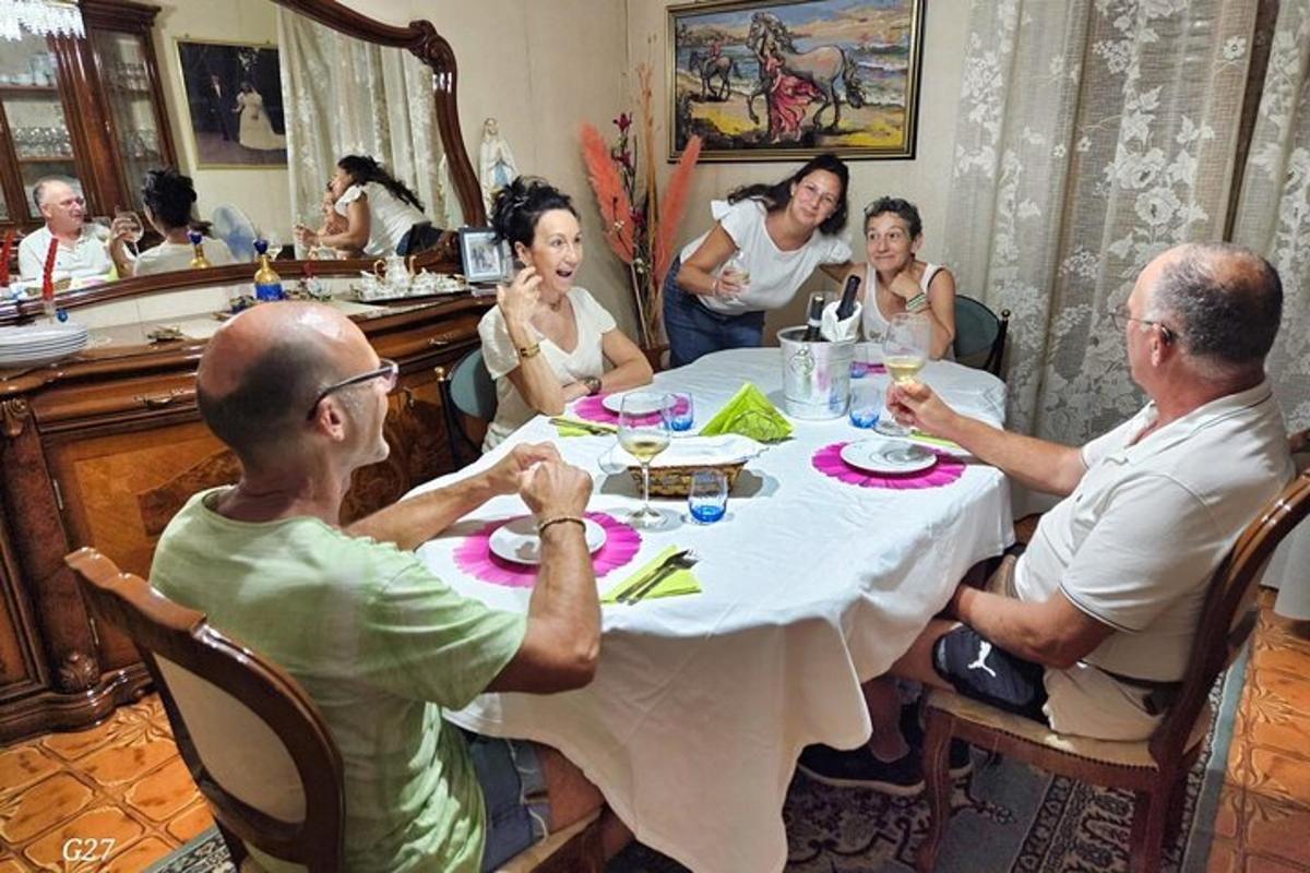 skupina lidí sedících kolem stolu před zrcadlem