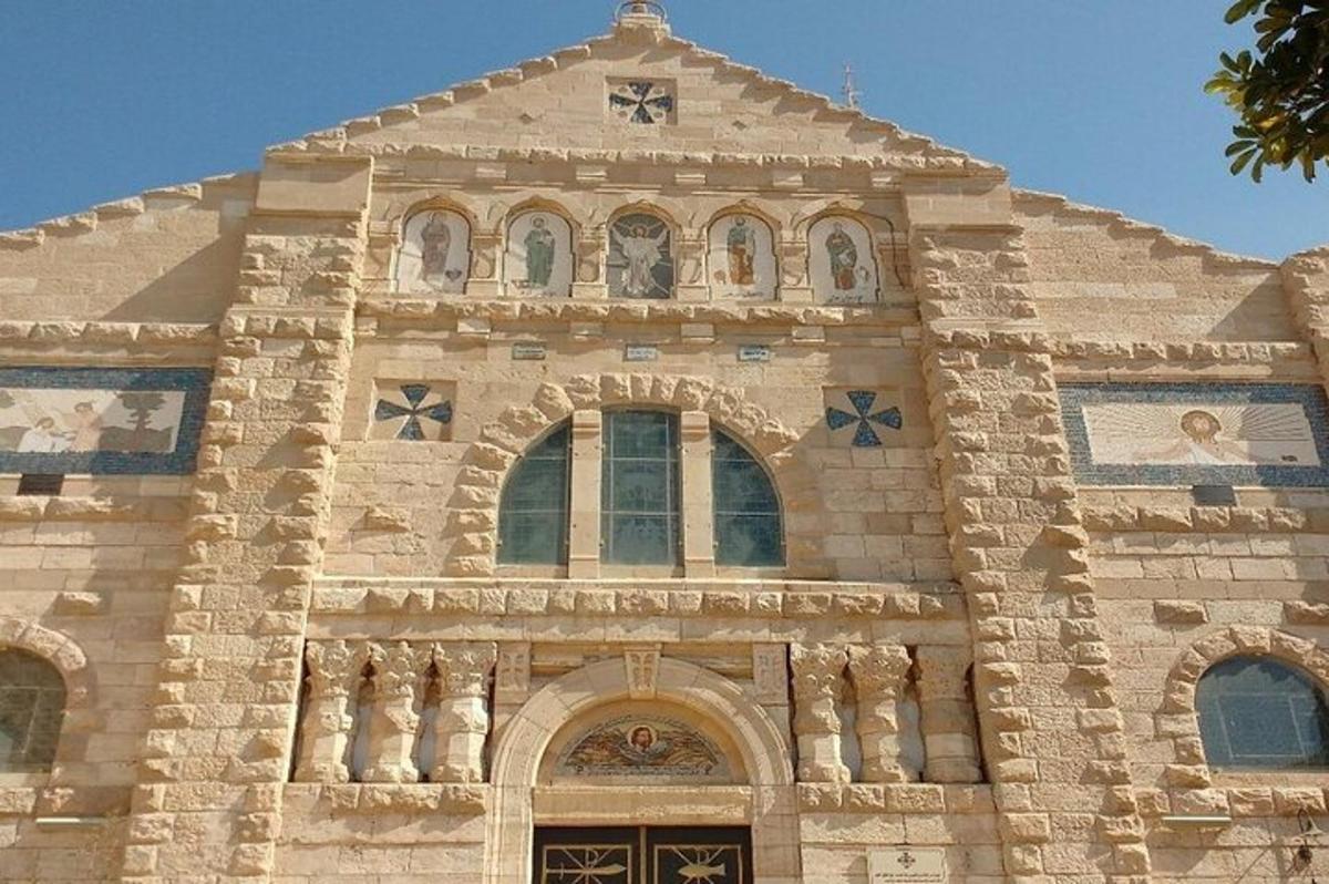 a large stone building with mosaics on the facade