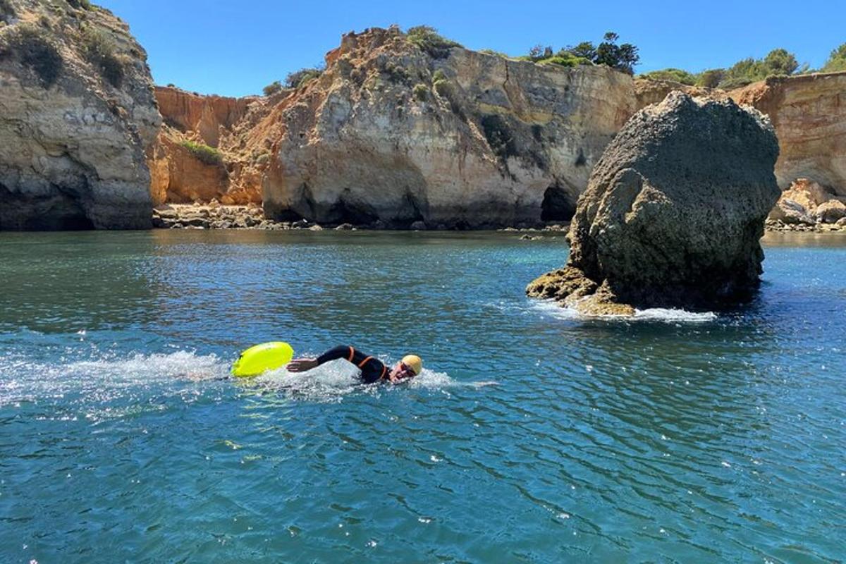 a person in the water with a yellow frisbee
