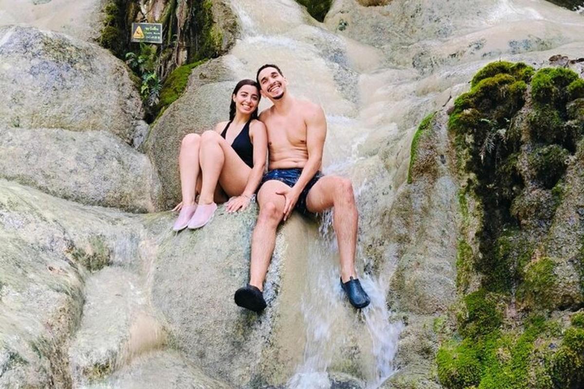 a man and a woman sitting on some rocks