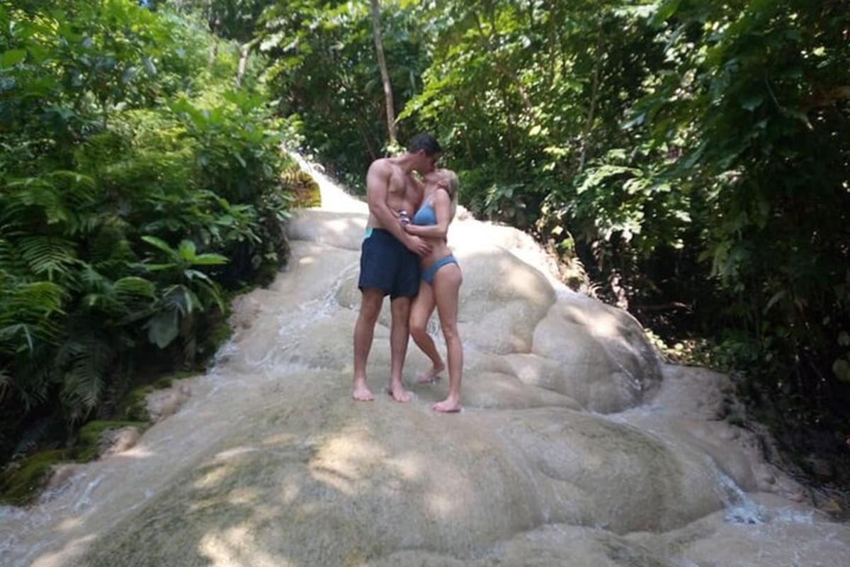 a man and a woman standing on a rock
