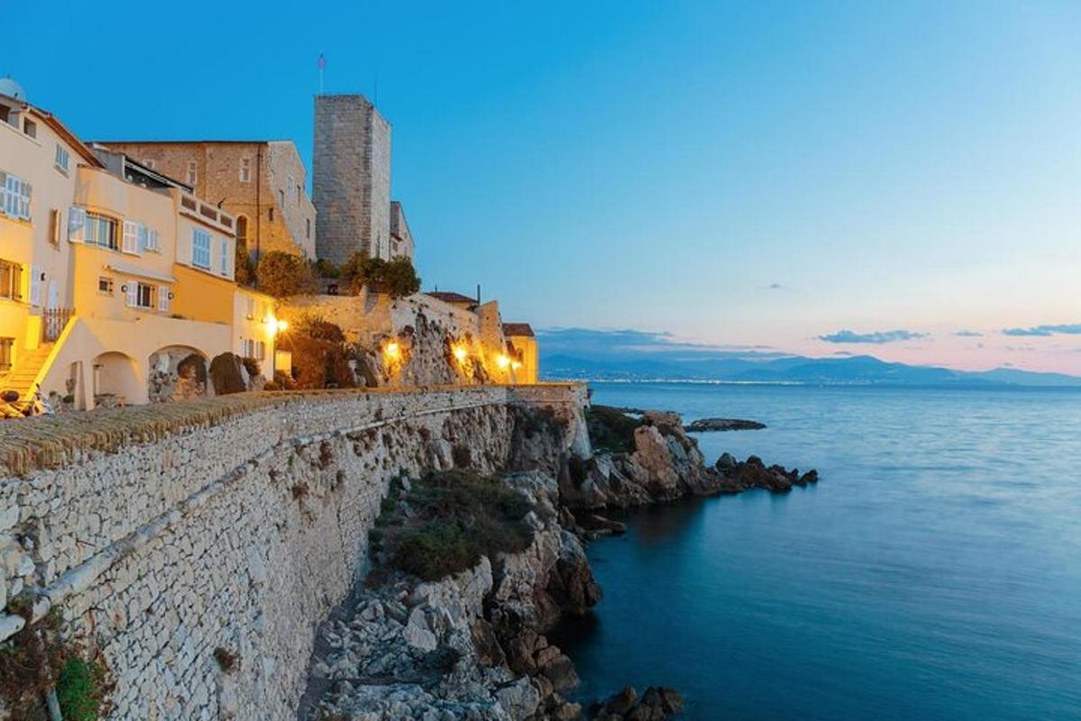 a group of buildings on a cliff next to the water
