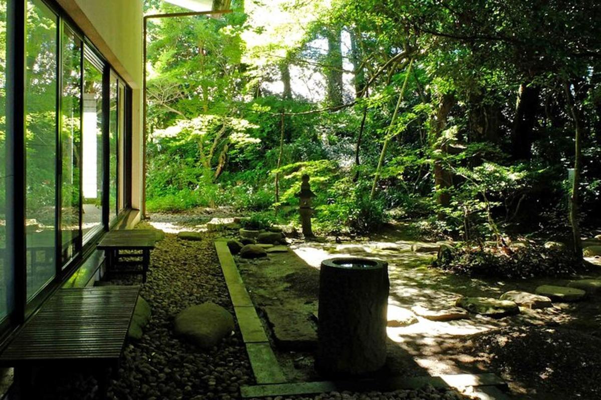 a porch of a house with a bench and trees