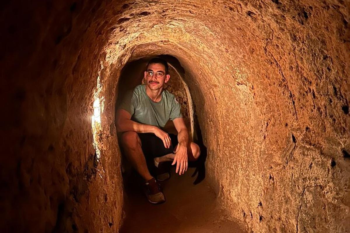 a man sitting in a tunnel in a cave