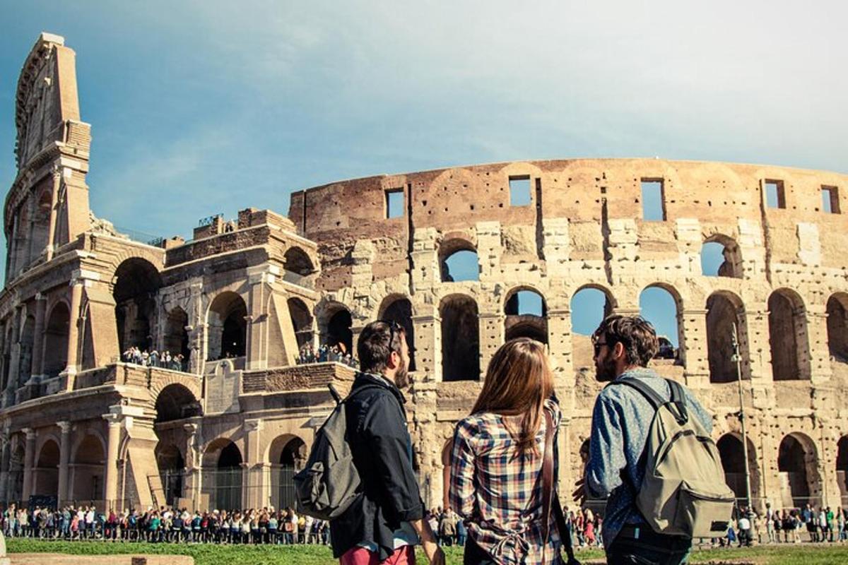 a group of people walking around the coliseum