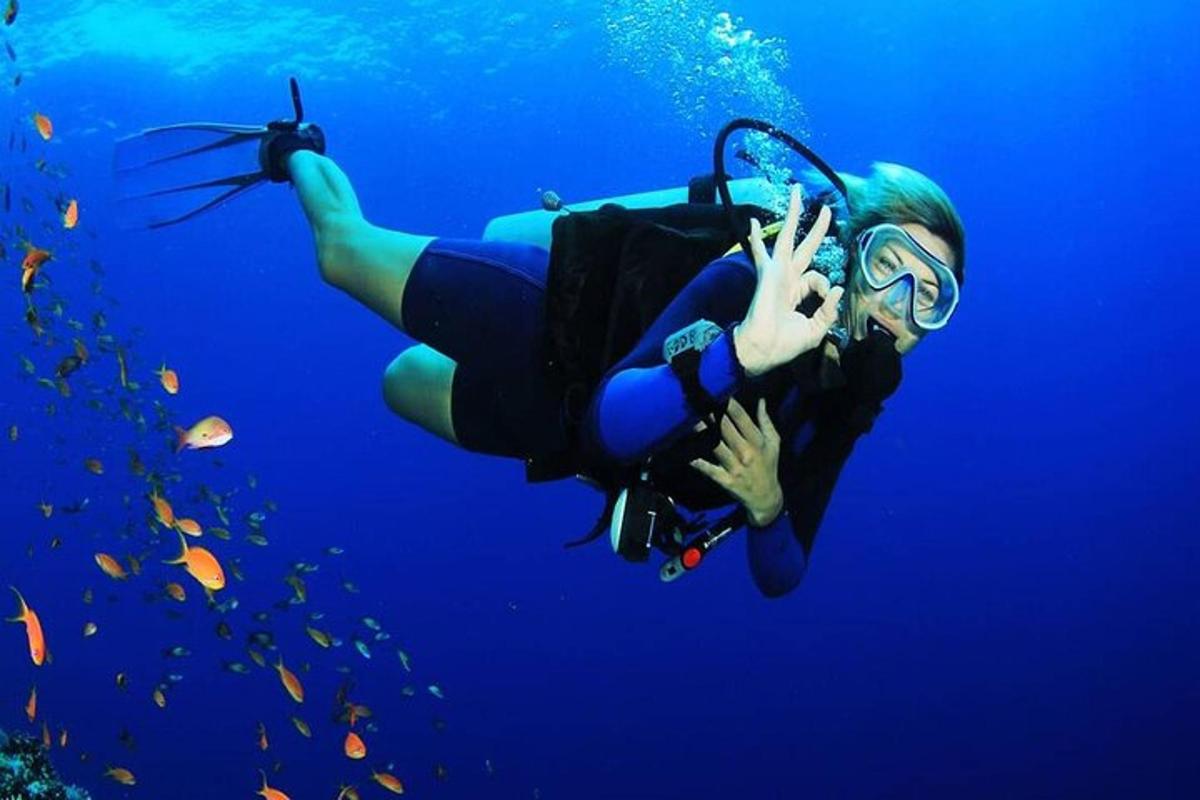 a woman is swimming in the blue water