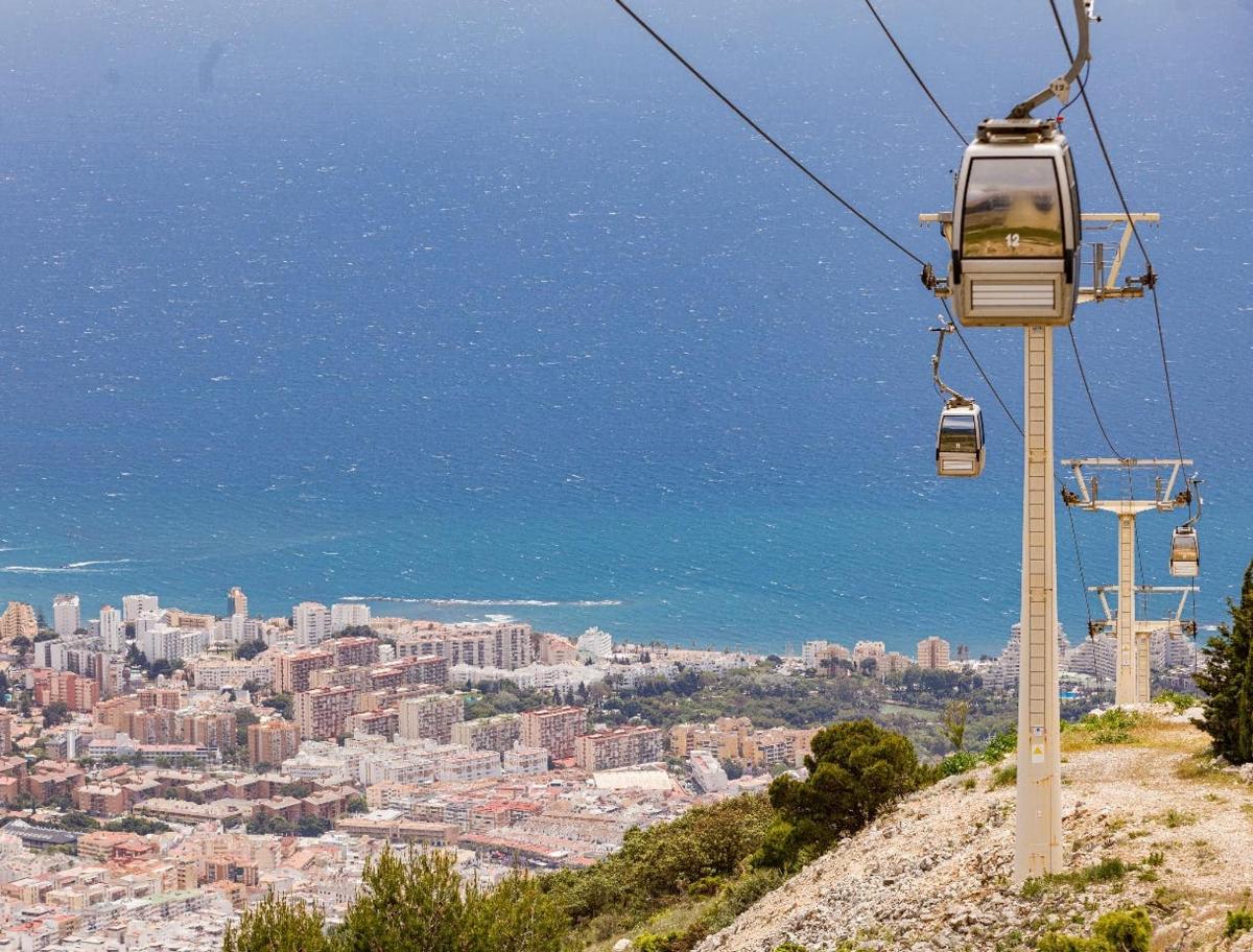 a gondola ride up a hill with a city