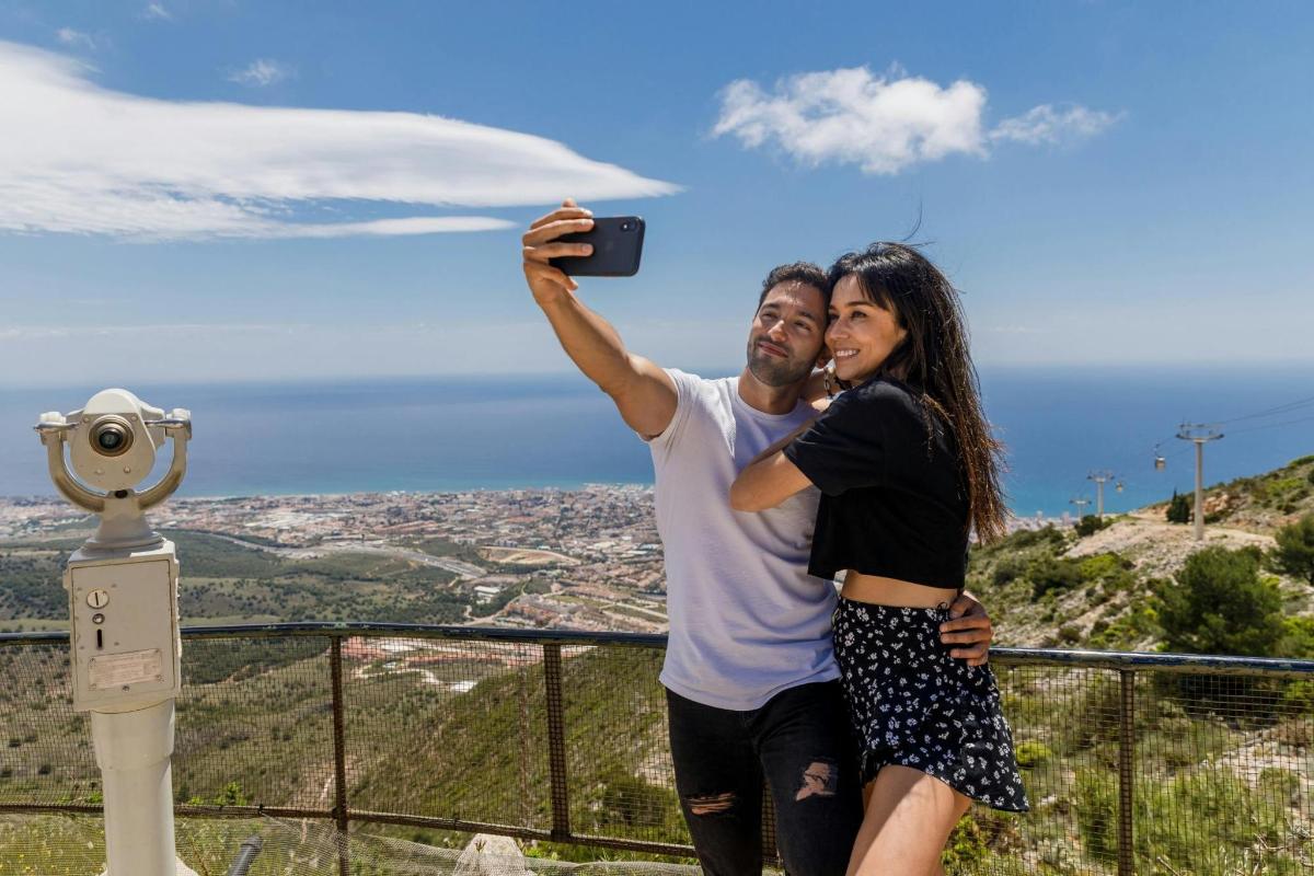 a man and woman taking a picture with a camera