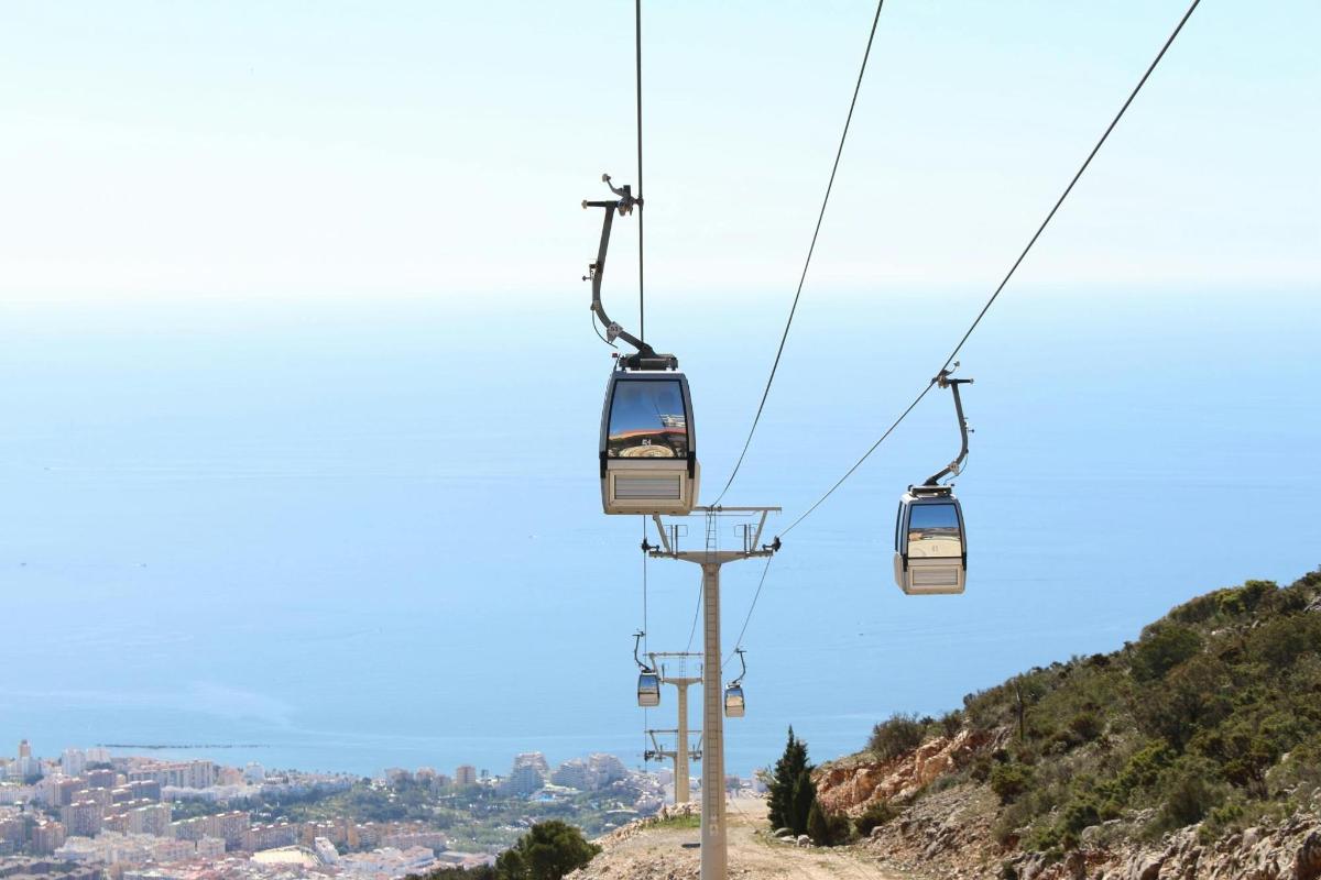 a group of gondolas on a ski lift