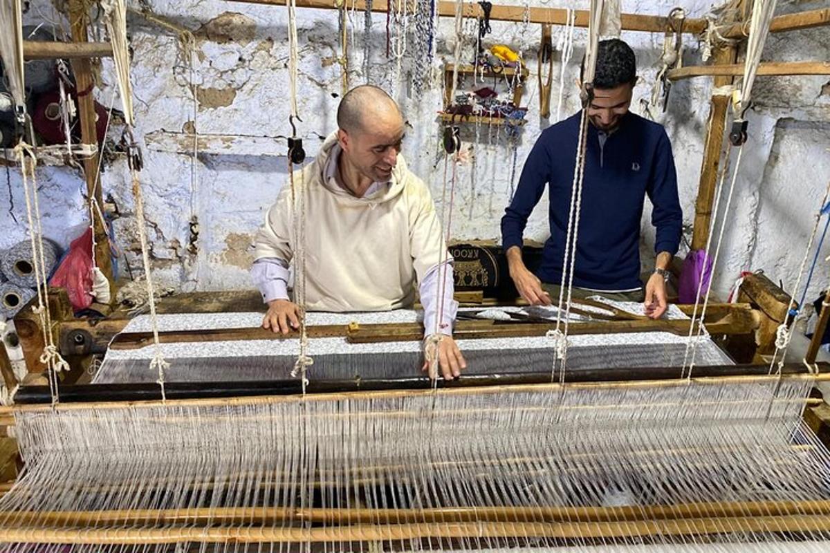 two men are working on a weaving machine