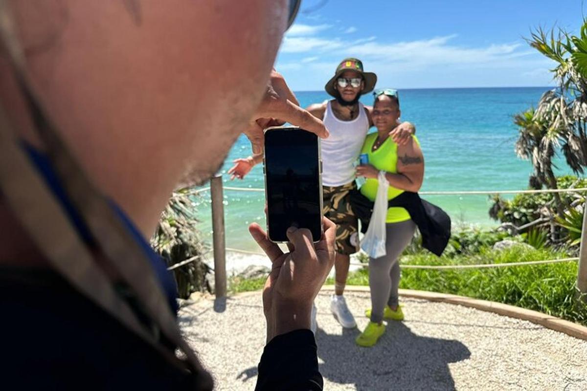 un uomo che scatta una foto a due donne sulla spiaggia