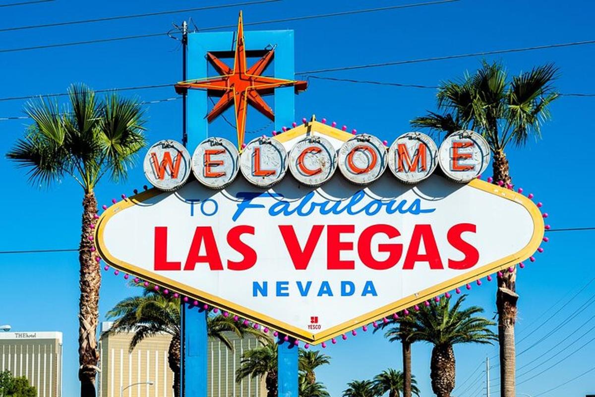 a sign for las vegas with palm trees in the background
