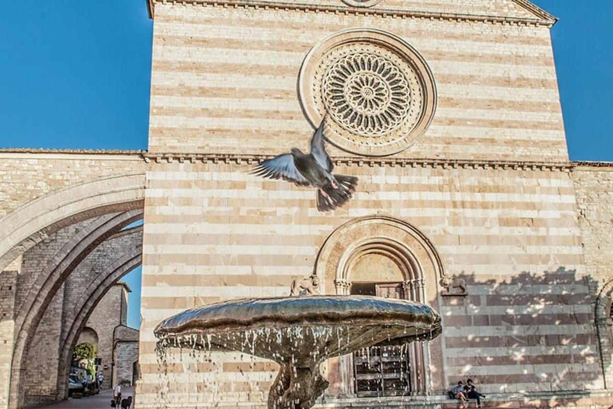 a bird flying over a fountain in front of a building