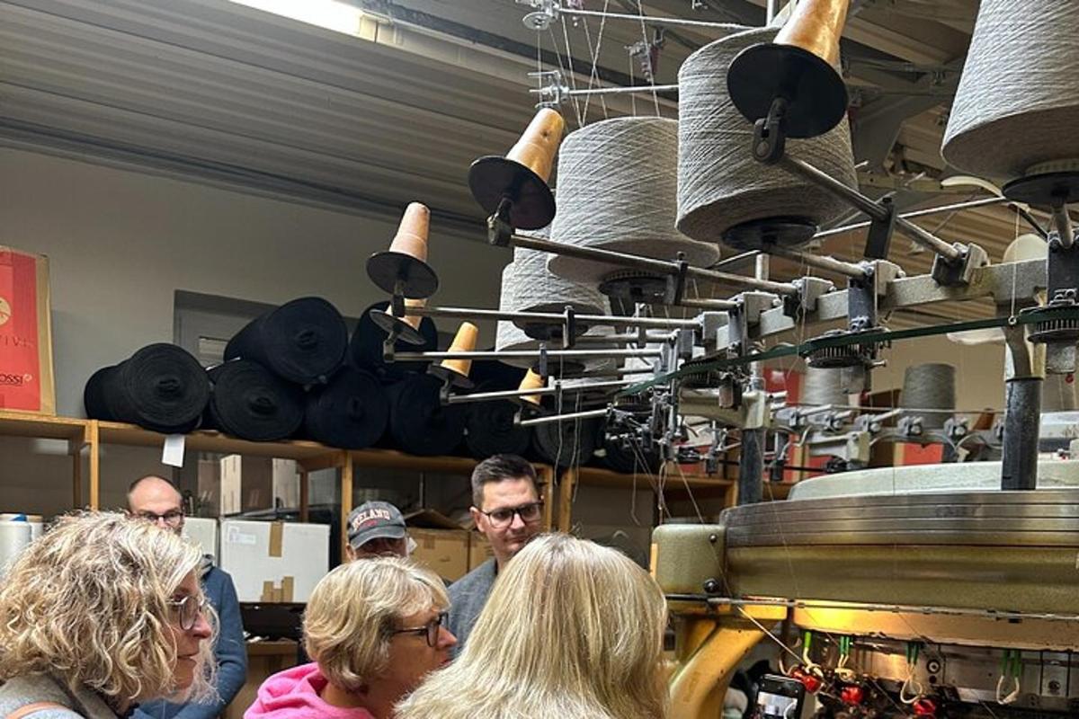 a group of people standing around in a kitchen