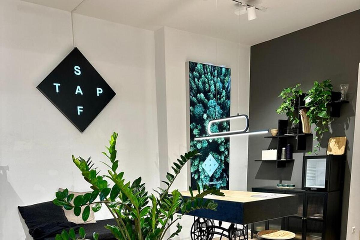 a room with a desk and a table with plants