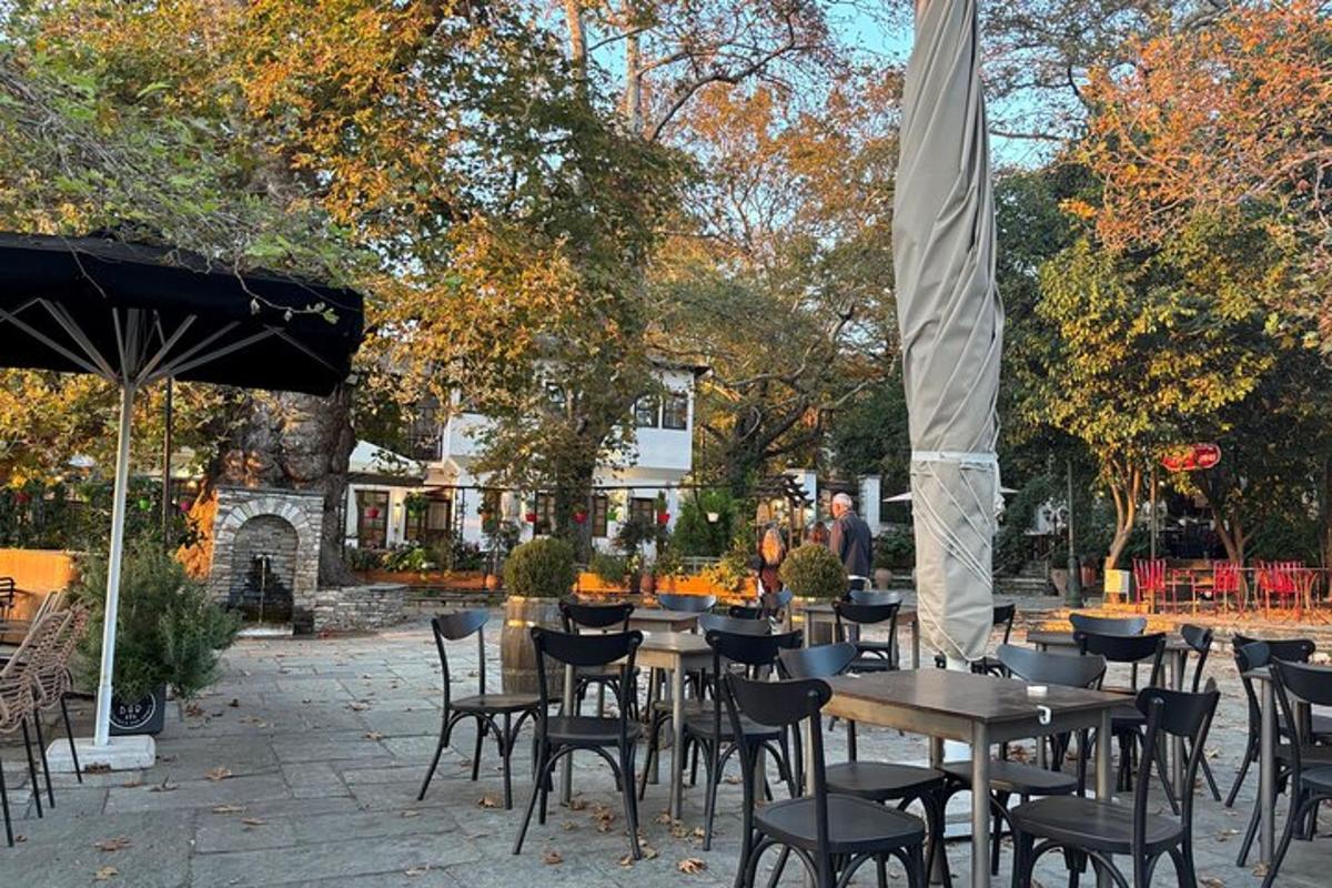 a group of tables and chairs in a courtyard