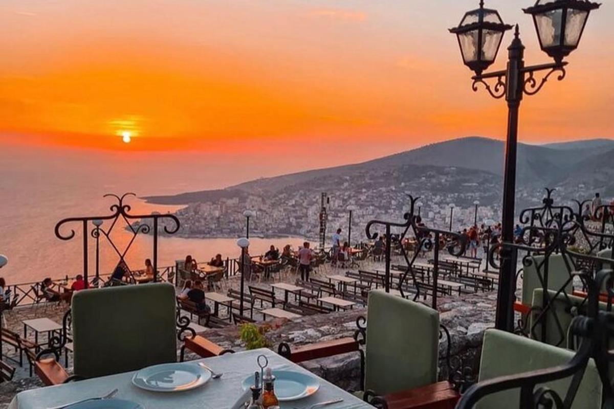 a restaurant with a view of the ocean at sunset