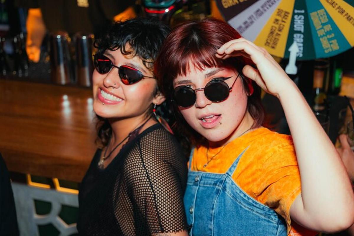 two women standing next to each other wearing sunglasses
