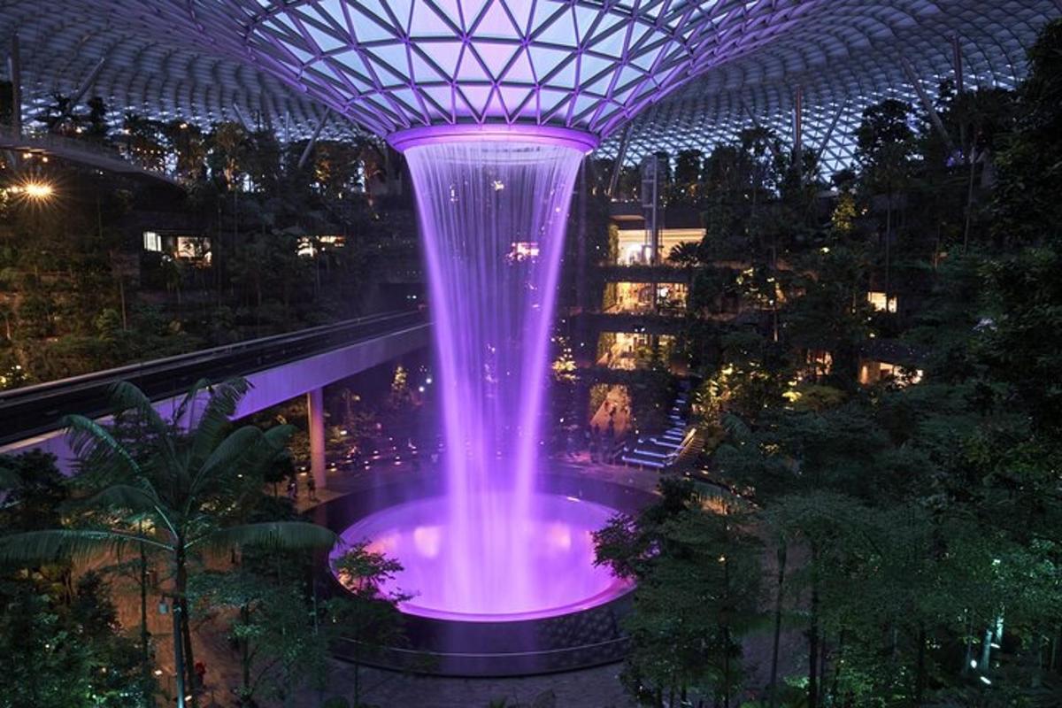 a fountain in a building with purple lights