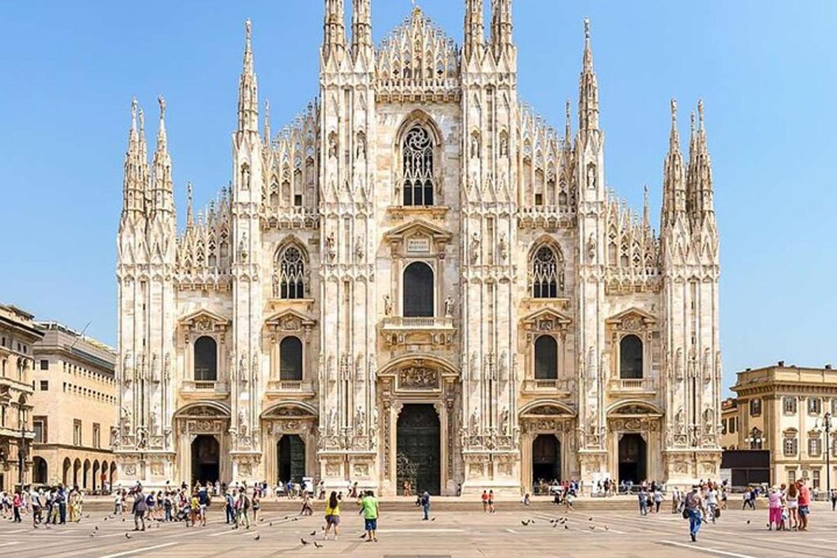 a large cathedral with people walking in front of it