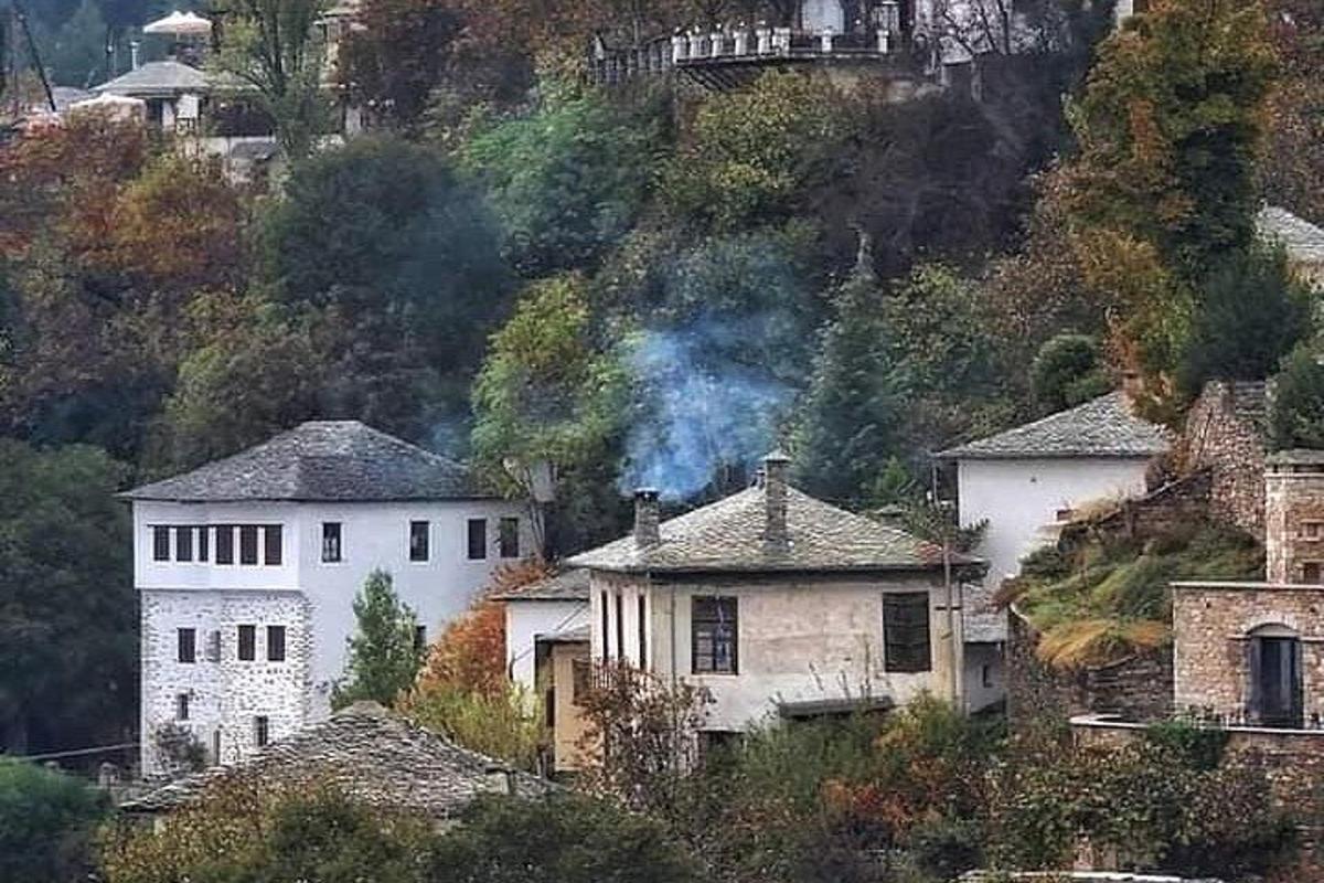 a house on a hill with smoke coming out of it