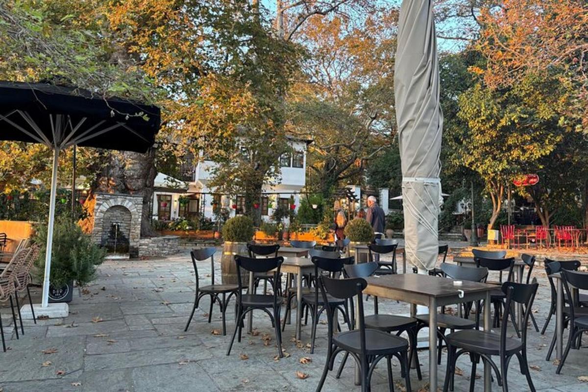 a group of tables and chairs in a courtyard