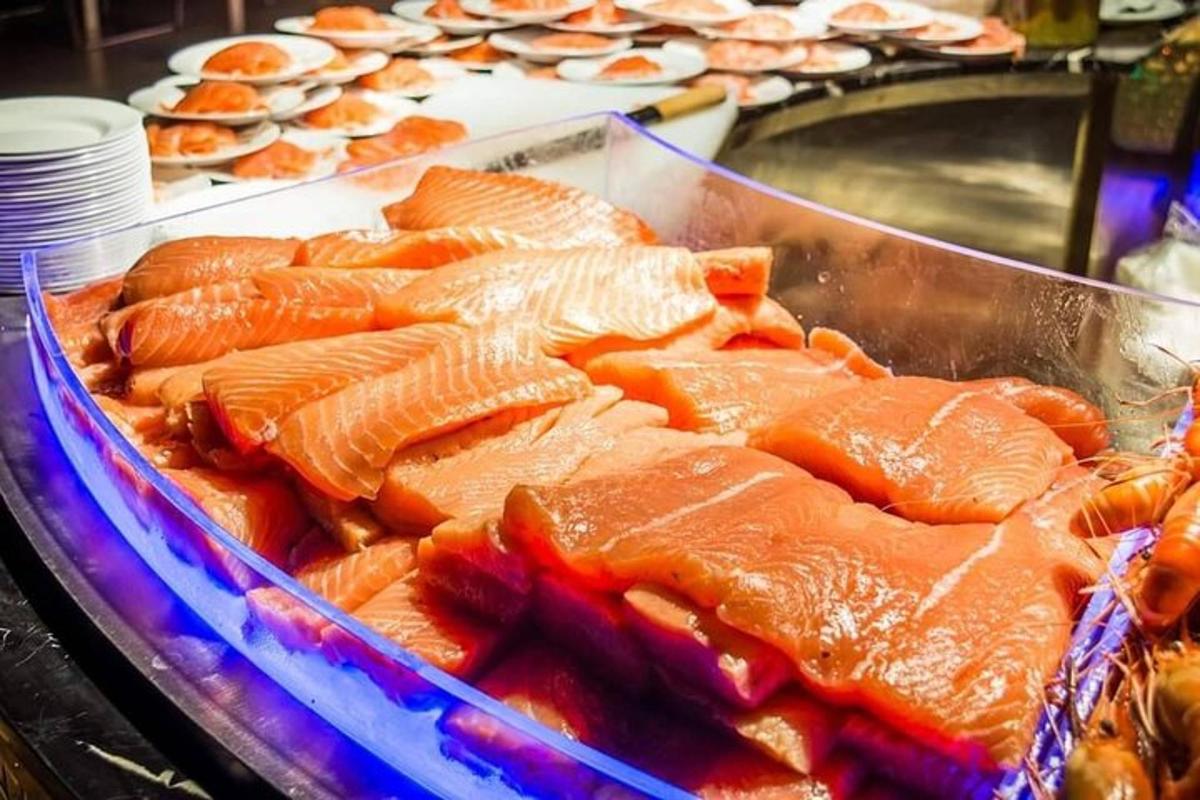 a tray of food with salmon and other foods