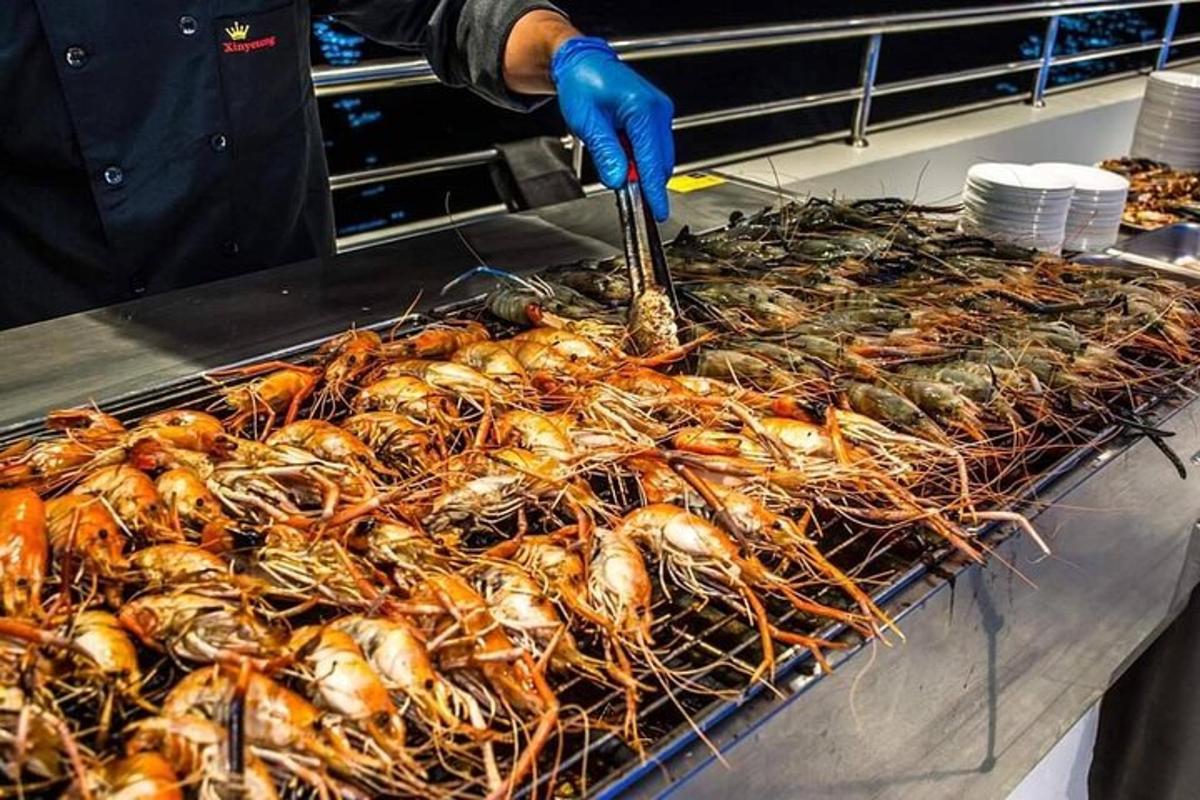 a person is cooking a bunch of food on a grill