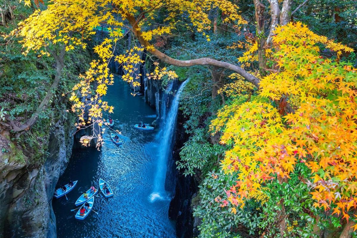 a view of a waterfall with boats in the water
