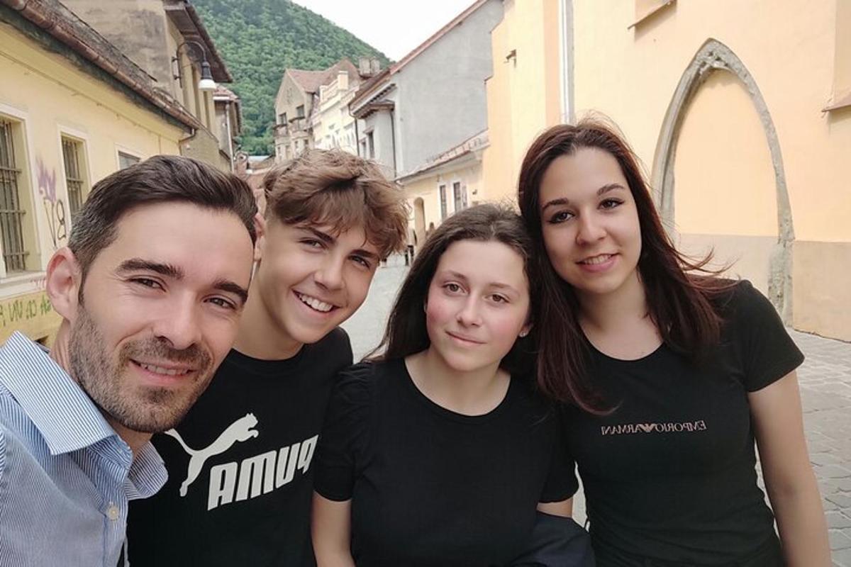 a group of people posing for a picture on a street