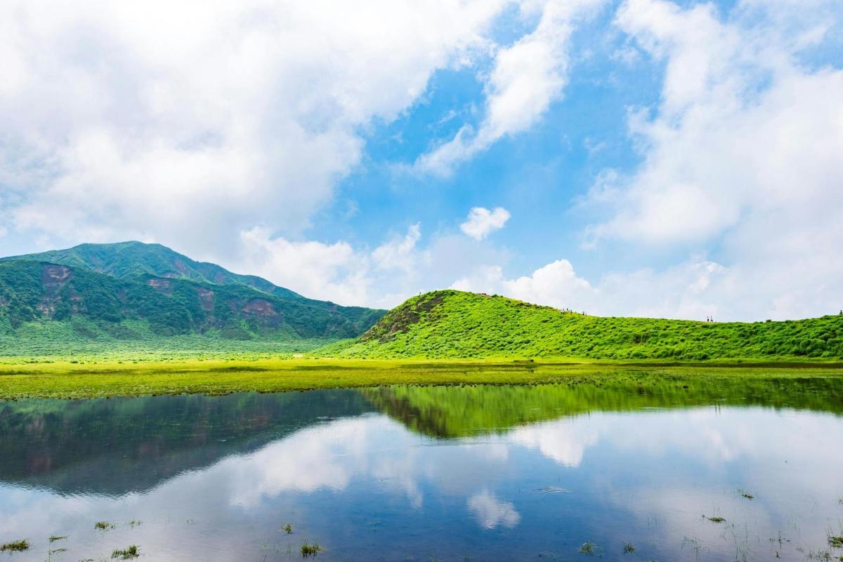 a reflection of a mountain in a body of water