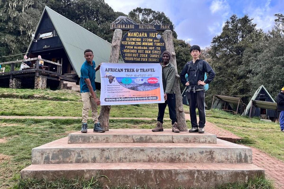 a group of three boys standing next to a sign