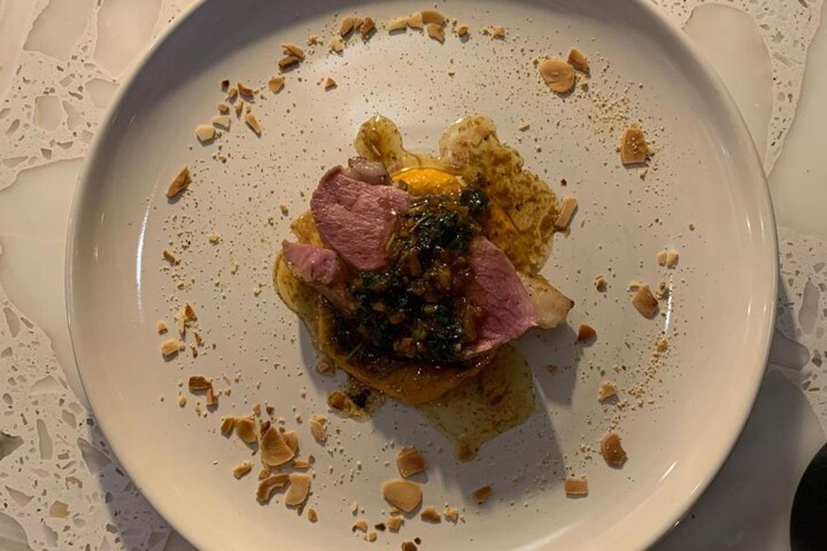 un piatto bianco con carne e altro cibo sopra