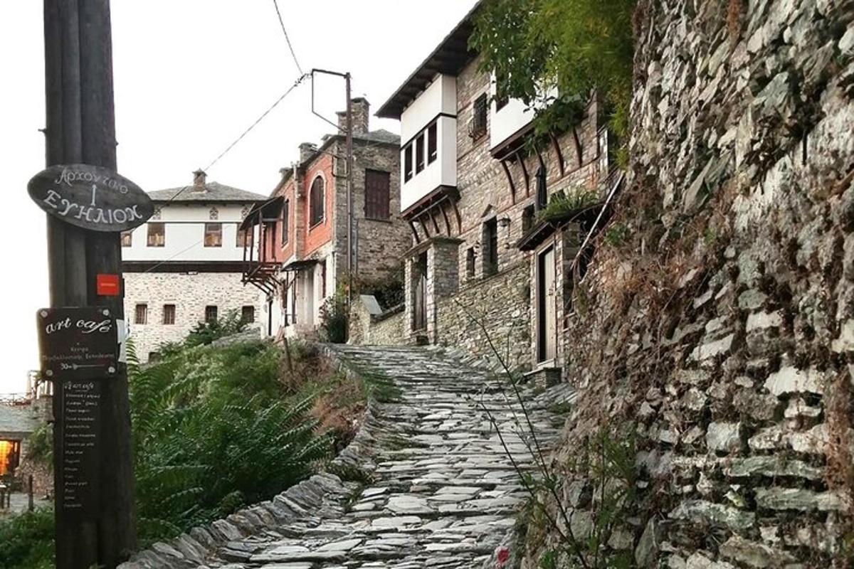 an old stone path in a town with buildings