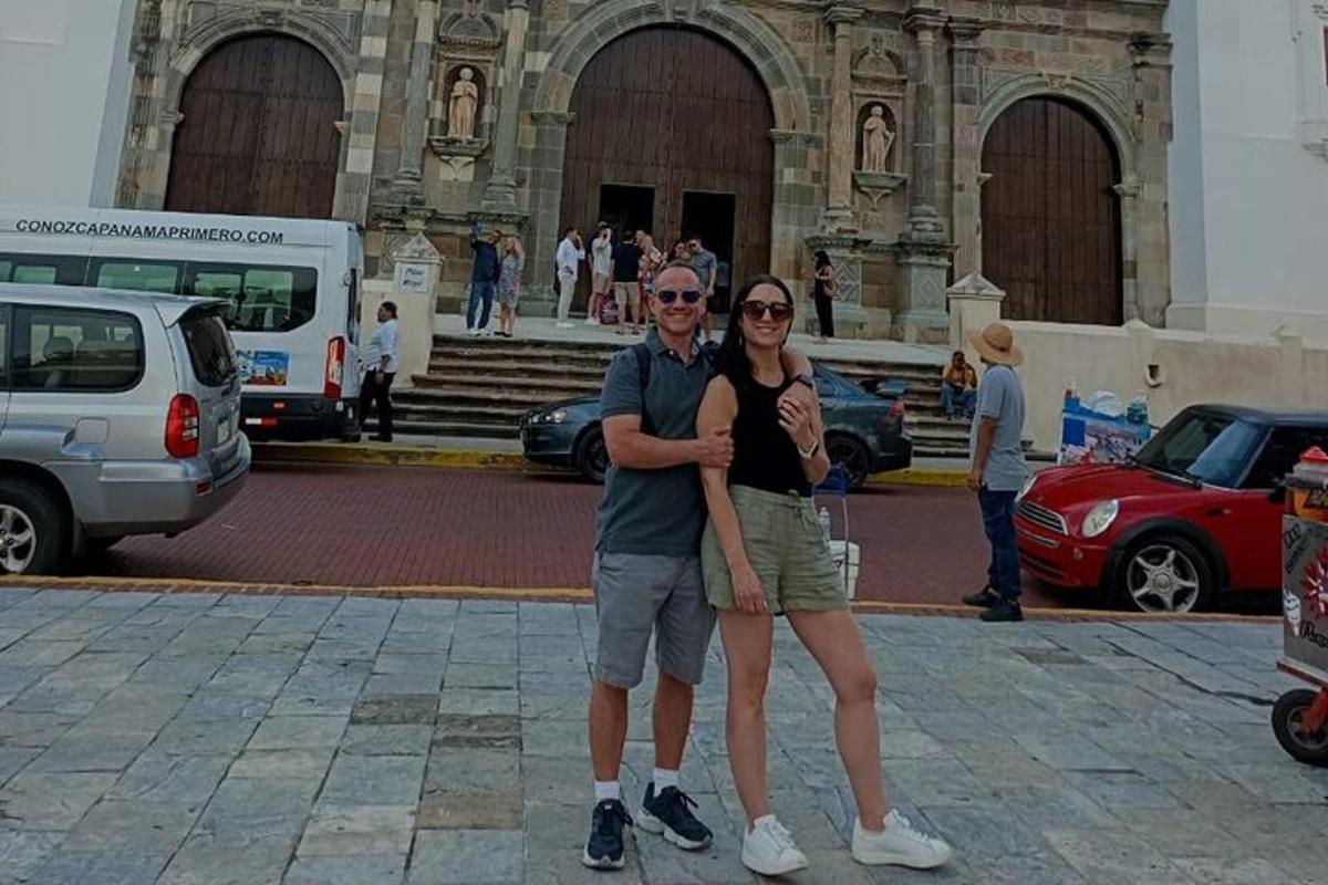 a man and a woman standing in front of a building