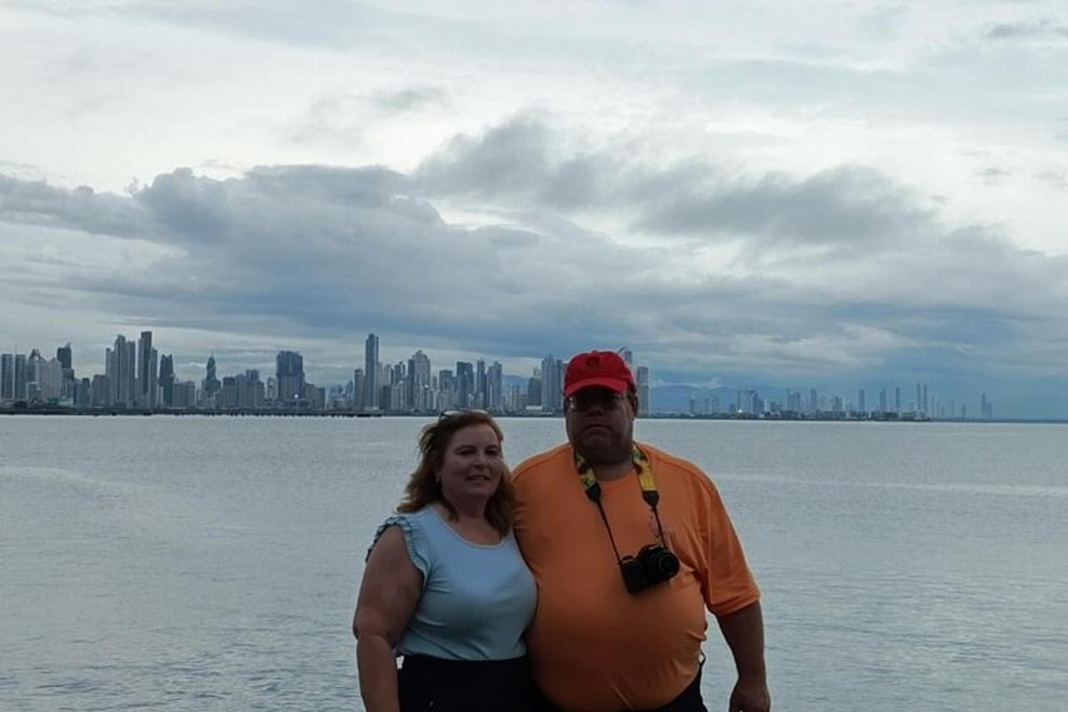 a man and a woman standing in front of the water