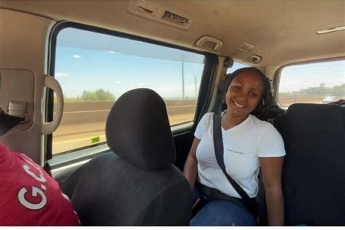 a woman sitting in the back seat of a car
