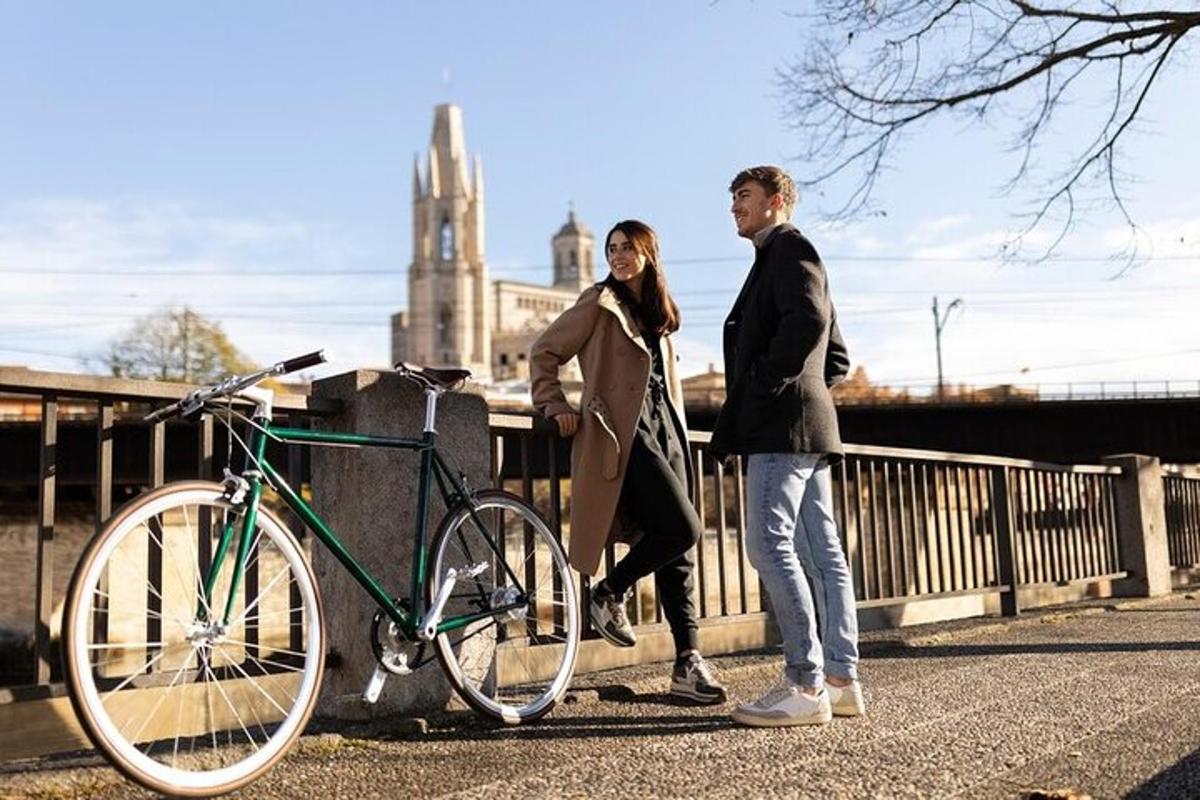 due persone in piedi accanto a una bicicletta su un ponte